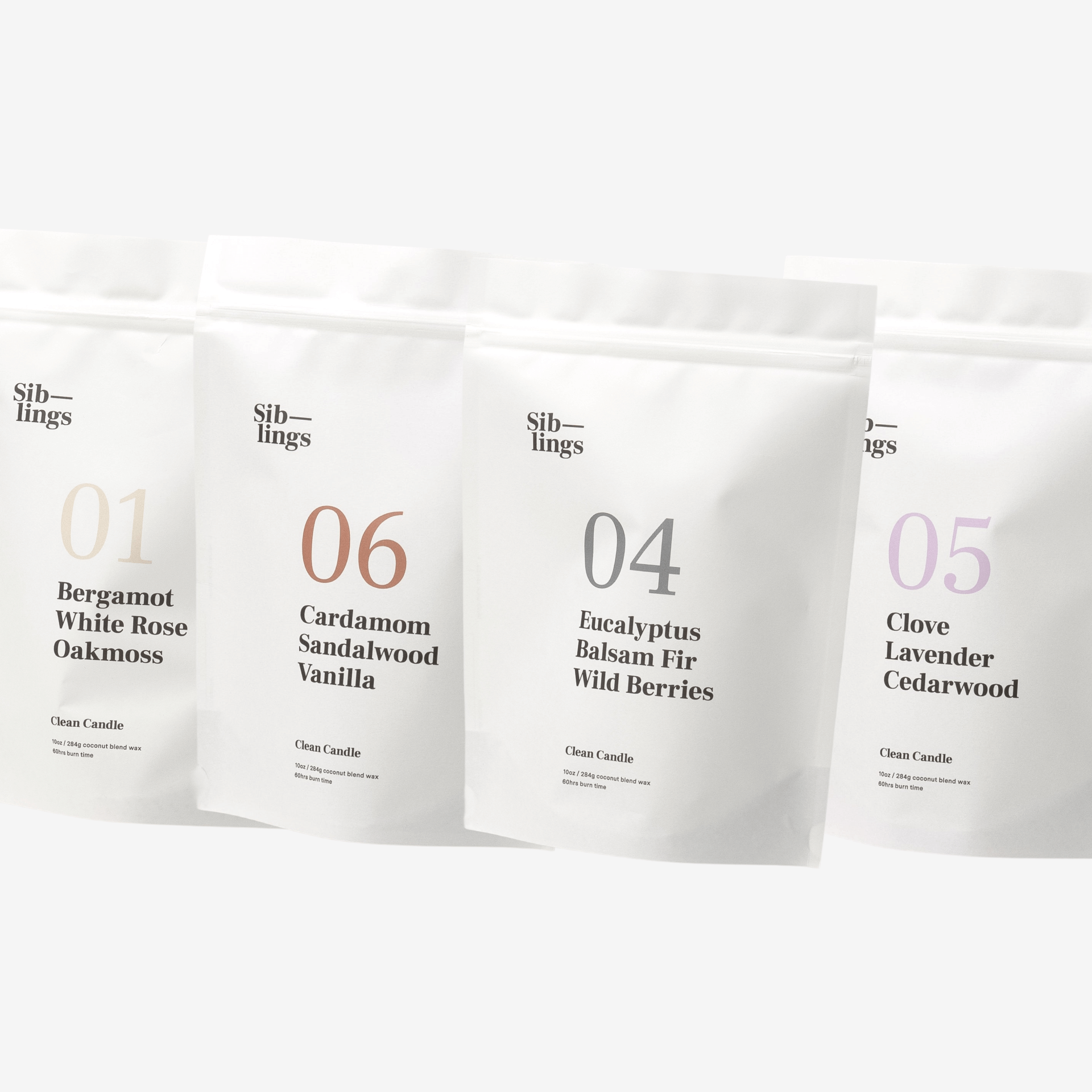 Four white Siblings candle pouches with scent labels on a clean white background, showcasing Bergamot, Eucalyptus, Clove, Cardamom, and Lavender fragrance notes.
