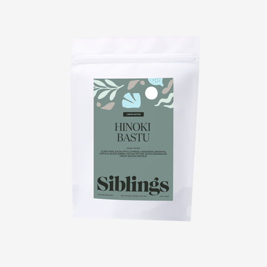 Eco-friendly candle in compostable bag, called 'Hinoki Bastu' with woody and herbal notes