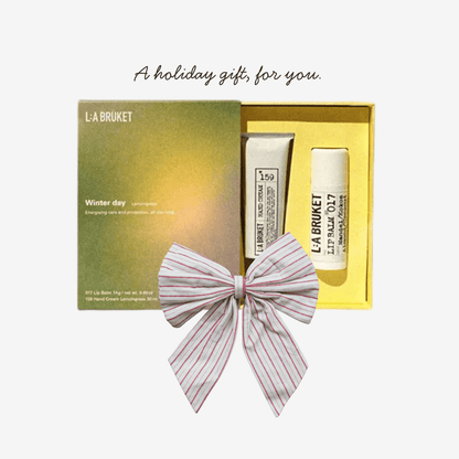 L:A BRUKET skincare set with a decorative bow in a yellow box on a white background