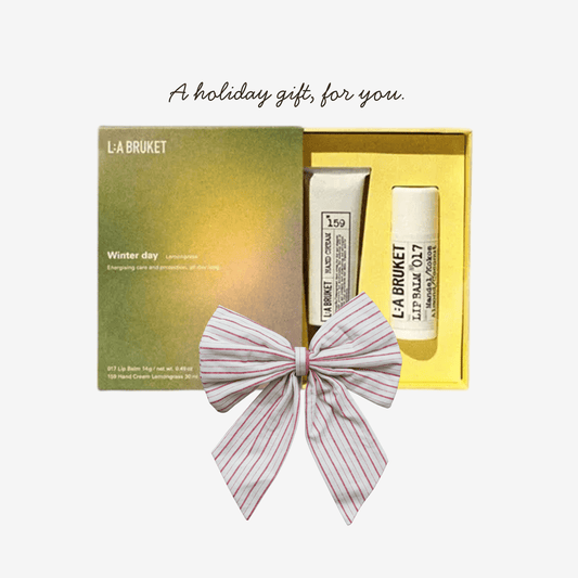 L:A BRUKET skincare set with a decorative bow in a yellow box on a white background