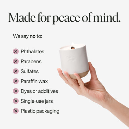 A hand holding a clean candle with text about product ingredients