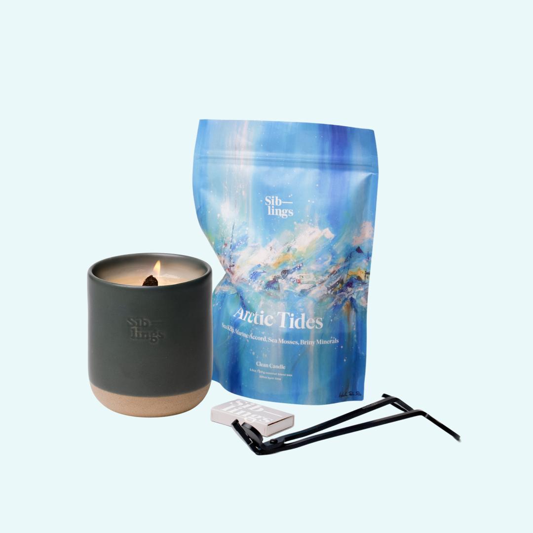 Siblings Arctic Tides candle starter set with Evergreen vessel, compostable wax refill bag, and black wick trimmer, showcasing an eco-friendly refill kit.