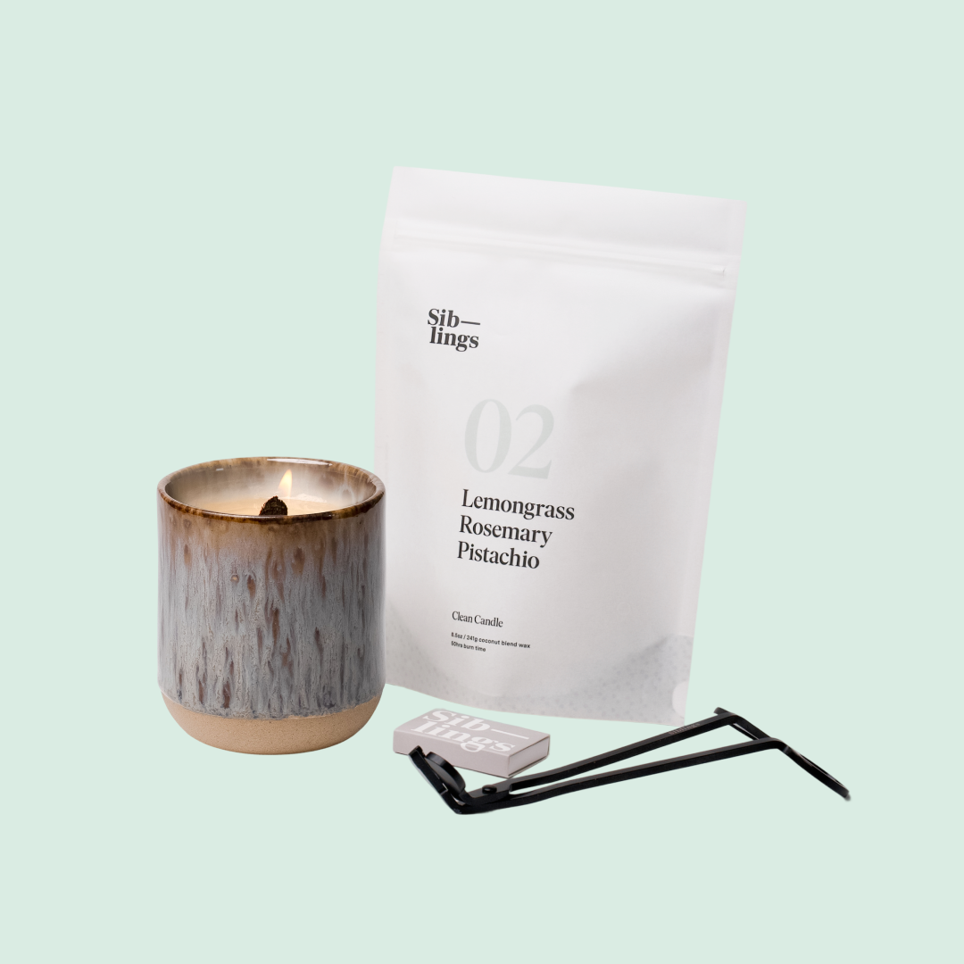 Siblings No. 02 candle starter set with Earth vessel, compostable wax refill bag (Lemongrass, Rosemary, Pistachio ), and black wick trimmer, showcasing an eco-friendly refill kit.