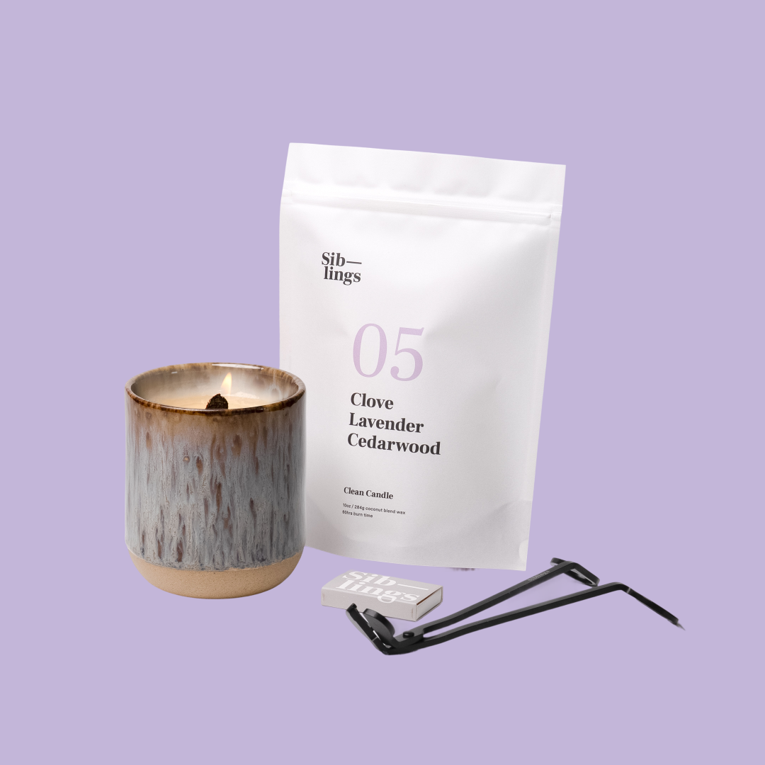 Siblings No. 05 candle starter set with Earth vessel, compostable wax refill bag (Clove, Lavender, Cedarwood ), and black wick trimmer, showcasing an eco-friendly refill kit.