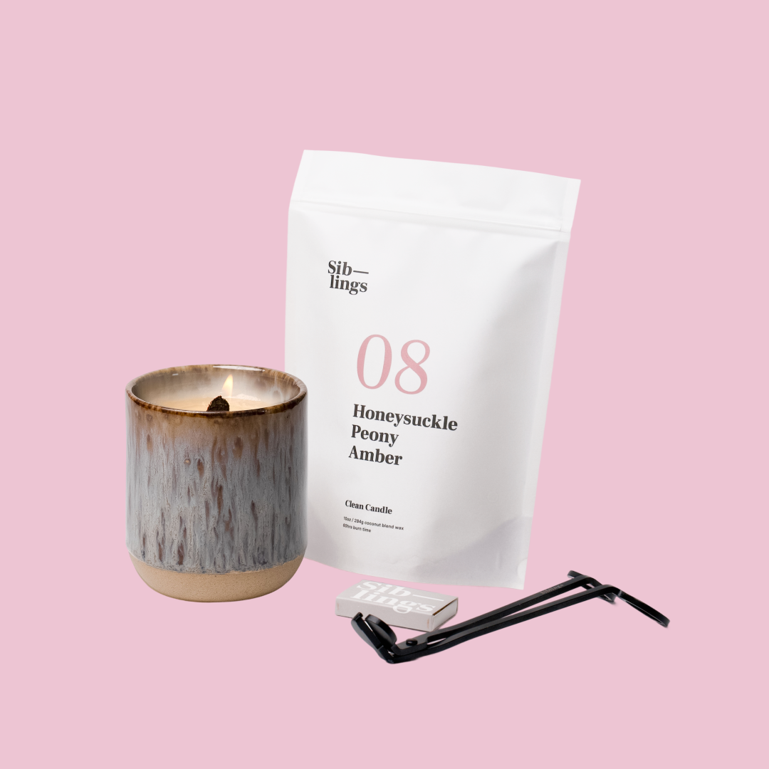 Siblings No. 08 candle starter set with Earth vessel, compostable wax refill bag (Peony, Honeysuckle, Amber ), and black wick trimmer, showcasing an eco-friendly refill kit.