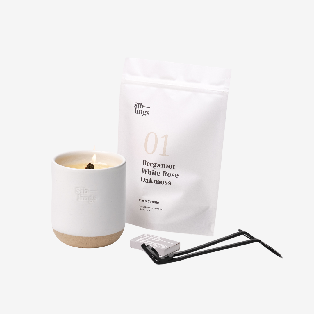 Siblings No. 01 candle starter set with White Cloud vessel, compostable wax refill bag (Bergamot, White Rose, Oakmoss), and black wick trimmer, showcasing an eco-friendly refill kit.