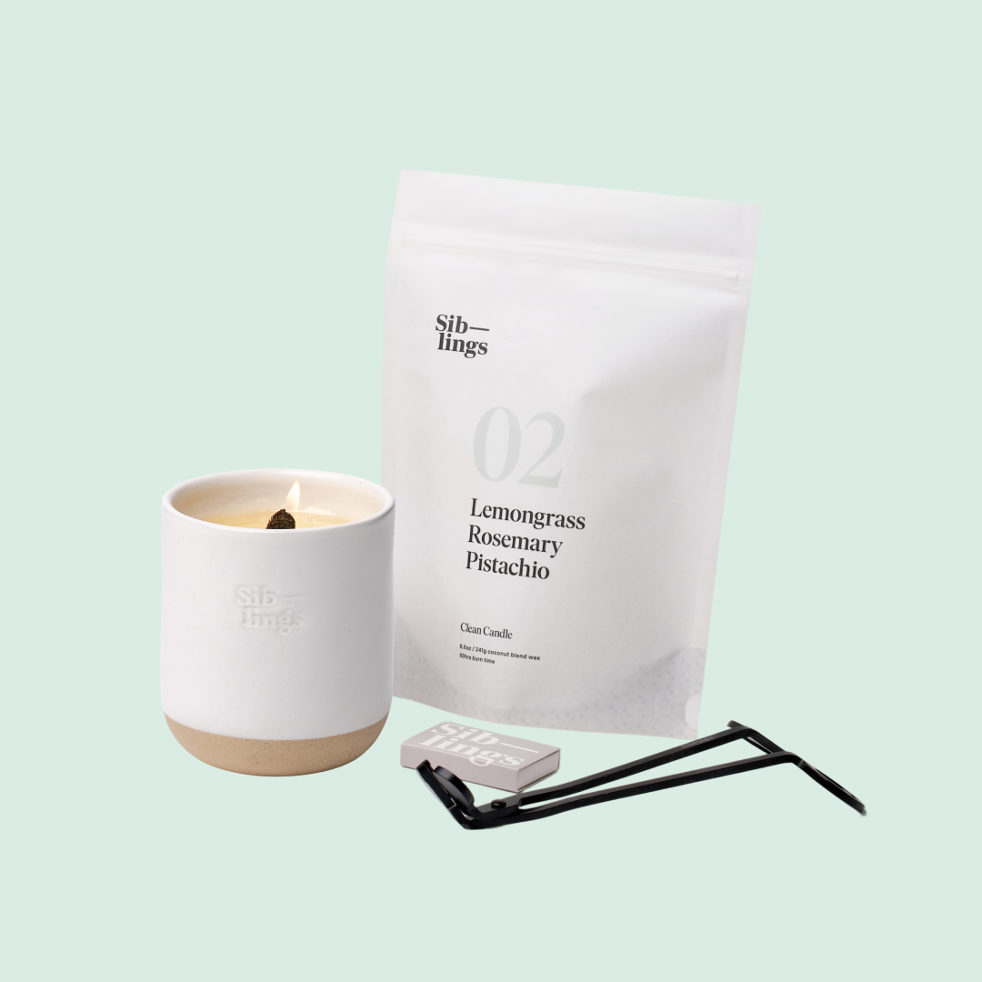 Siblings No. 02 candle starter set with White Cloud vessel, compostable wax refill bag (Lemongrass, Rosemary, Pistachio ), and black wick trimmer, showcasing an eco-friendly refill kit.