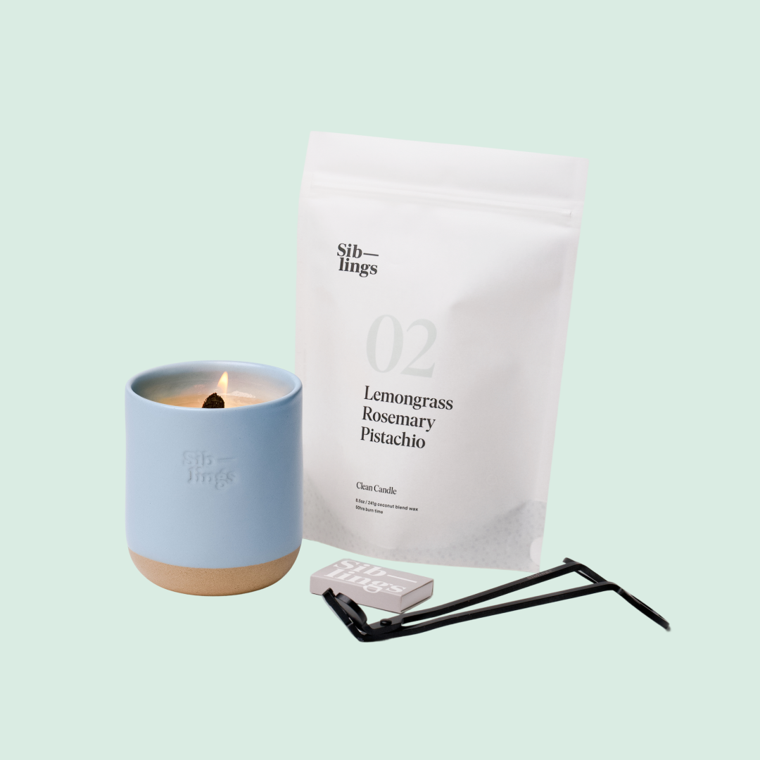 Siblings No. 02 candle starter set with Sky vessel, compostable wax refill bag (Lemongrass, Rosemary, Pistachio ), and black wick trimmer, showcasing an eco-friendly refill kit.