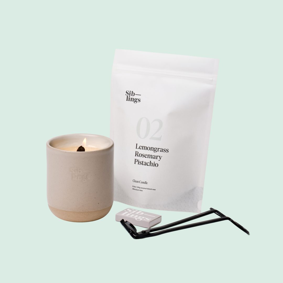 Siblings No. 02 candle starter set with Sand vessel, compostable wax refill bag (Lemongrass, Rosemary, Pistachio ), and black wick trimmer, showcasing an eco-friendly refill kit.