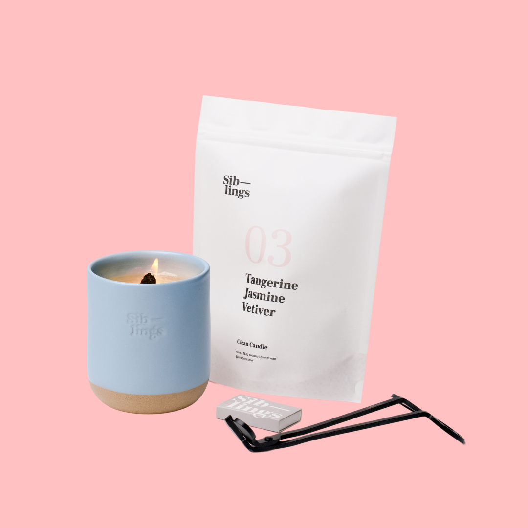 Siblings No. 03 candle starter set with Sky vessel, compostable wax refill bag (Tangerine, Jasmine, Vetiver ), and black wick trimmer, showcasing an eco-friendly refill kit.