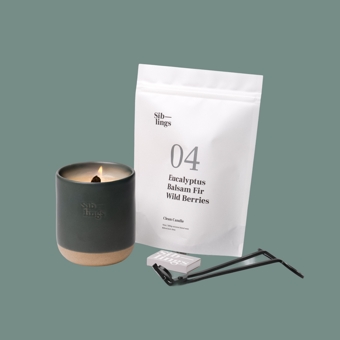 Siblings No. 04 candle starter set with Evergreen vessel, compostable wax refill bag (Eucalyptus, Balsam, Wild Berries ), and black wick trimmer, showcasing an eco-friendly refill kit.