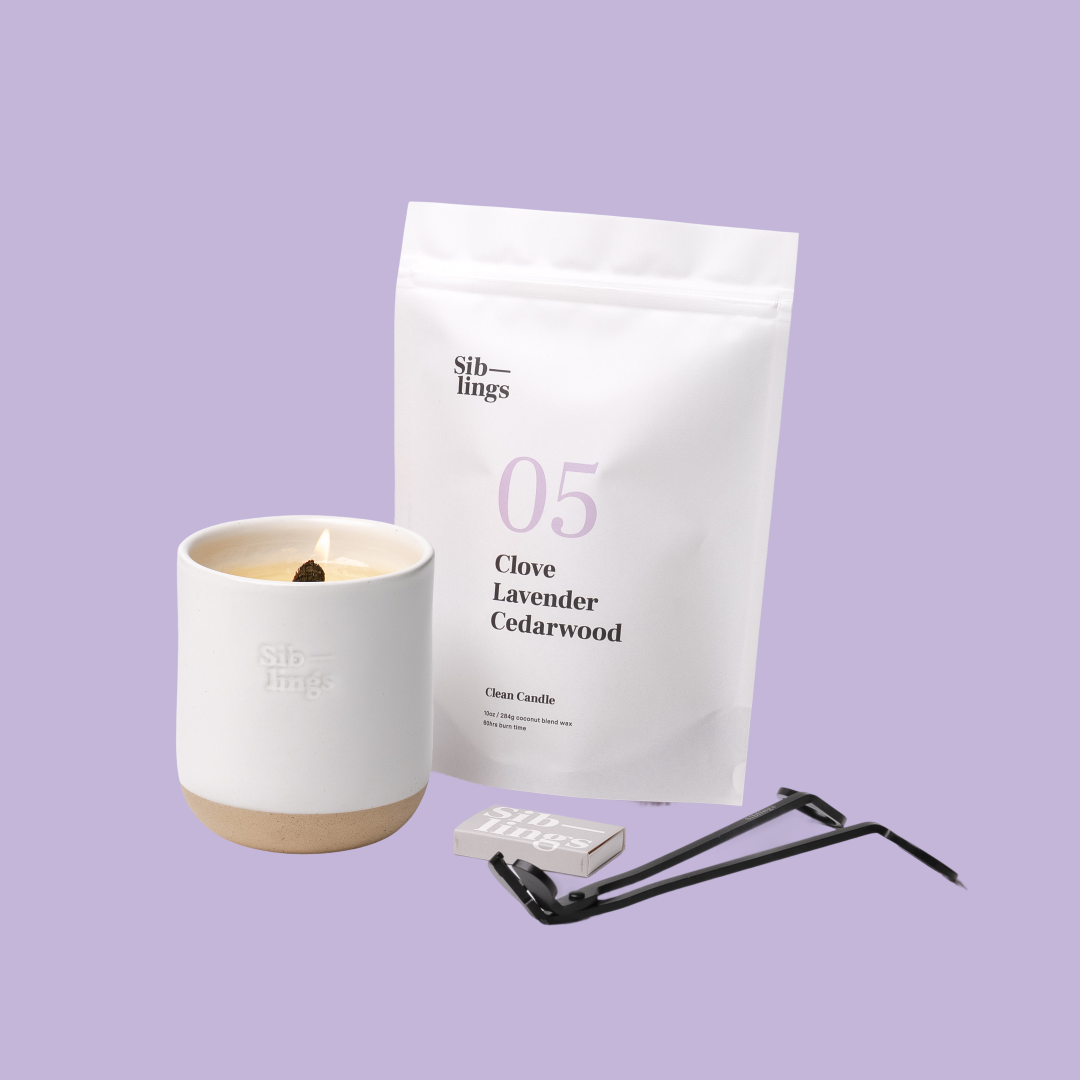 Siblings No. 05 candle starter set with White Cloud vessel, compostable wax refill bag (Clove, Lavender, Cedarwood ), and black wick trimmer, showcasing an eco-friendly refill kit.