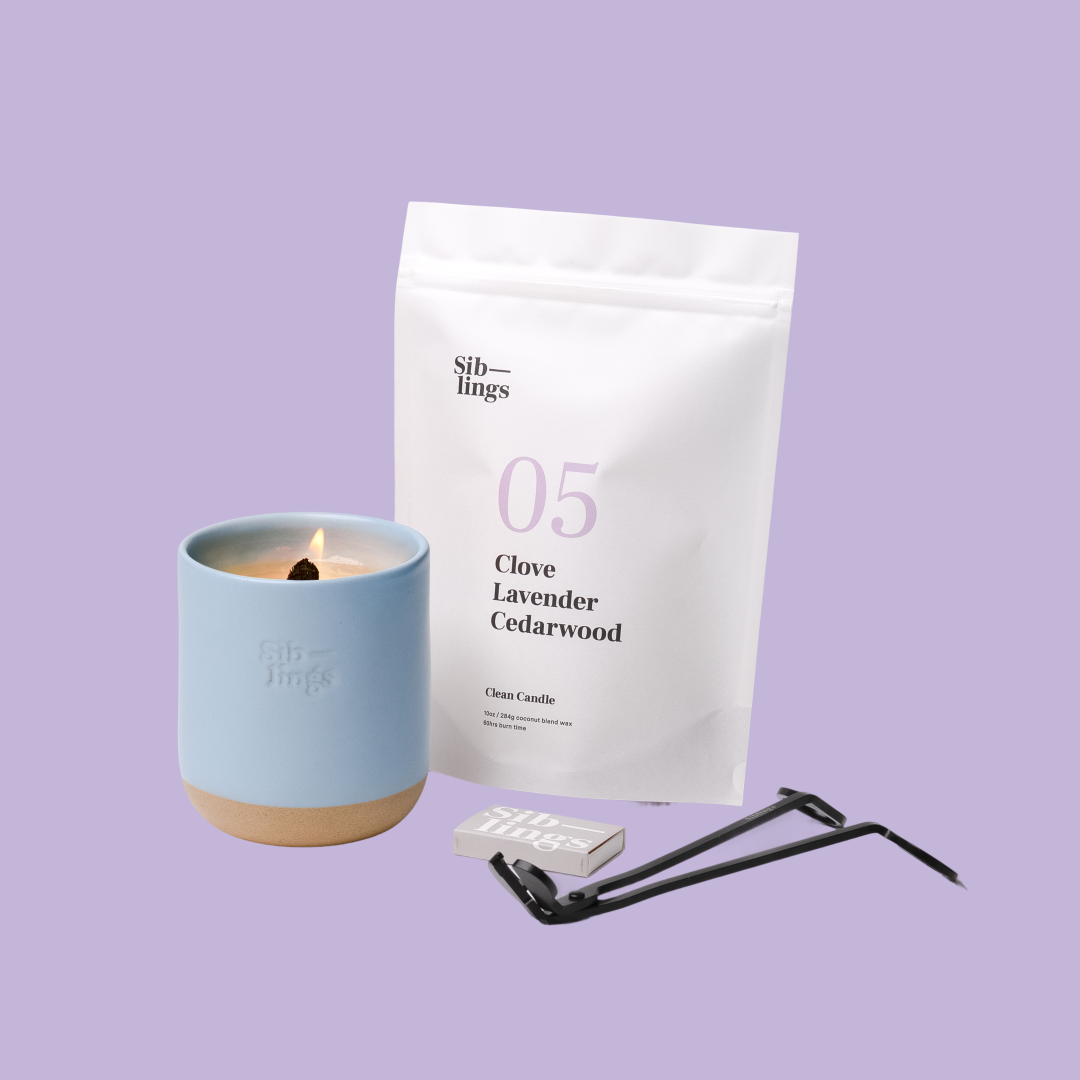 Siblings No. 05 candle starter set with Sky vessel, compostable wax refill bag (Clove, Lavender, Cedarwood ), and black wick trimmer, showcasing an eco-friendly refill kit.