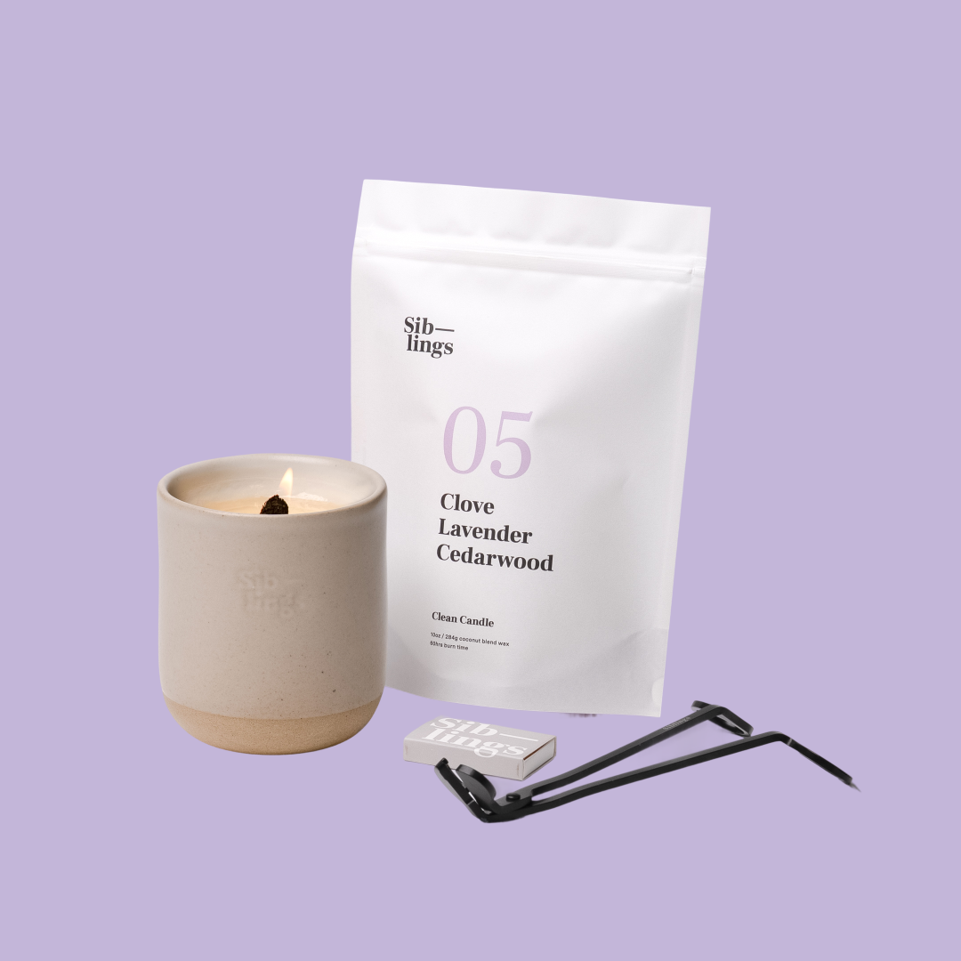 Siblings No. 05 candle starter set with Sand vessel, compostable wax refill bag (Clove, Lavender, Cedarwood ), and black wick trimmer, showcasing an eco-friendly refill kit.