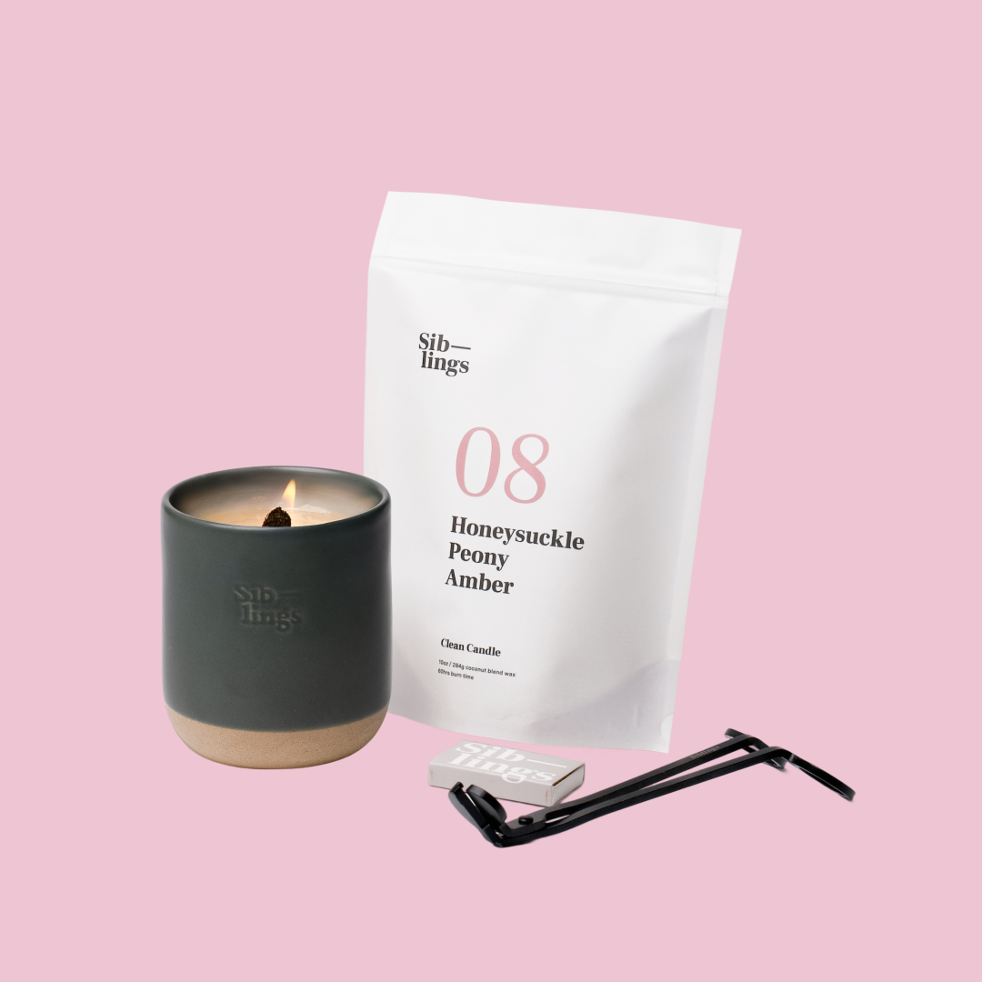 Siblings No. 08 candle starter set with Evergreen vessel, compostable wax refill bag (Peony, Honeysuckle, Amber ), and black wick trimmer, showcasing an eco-friendly refill kit.