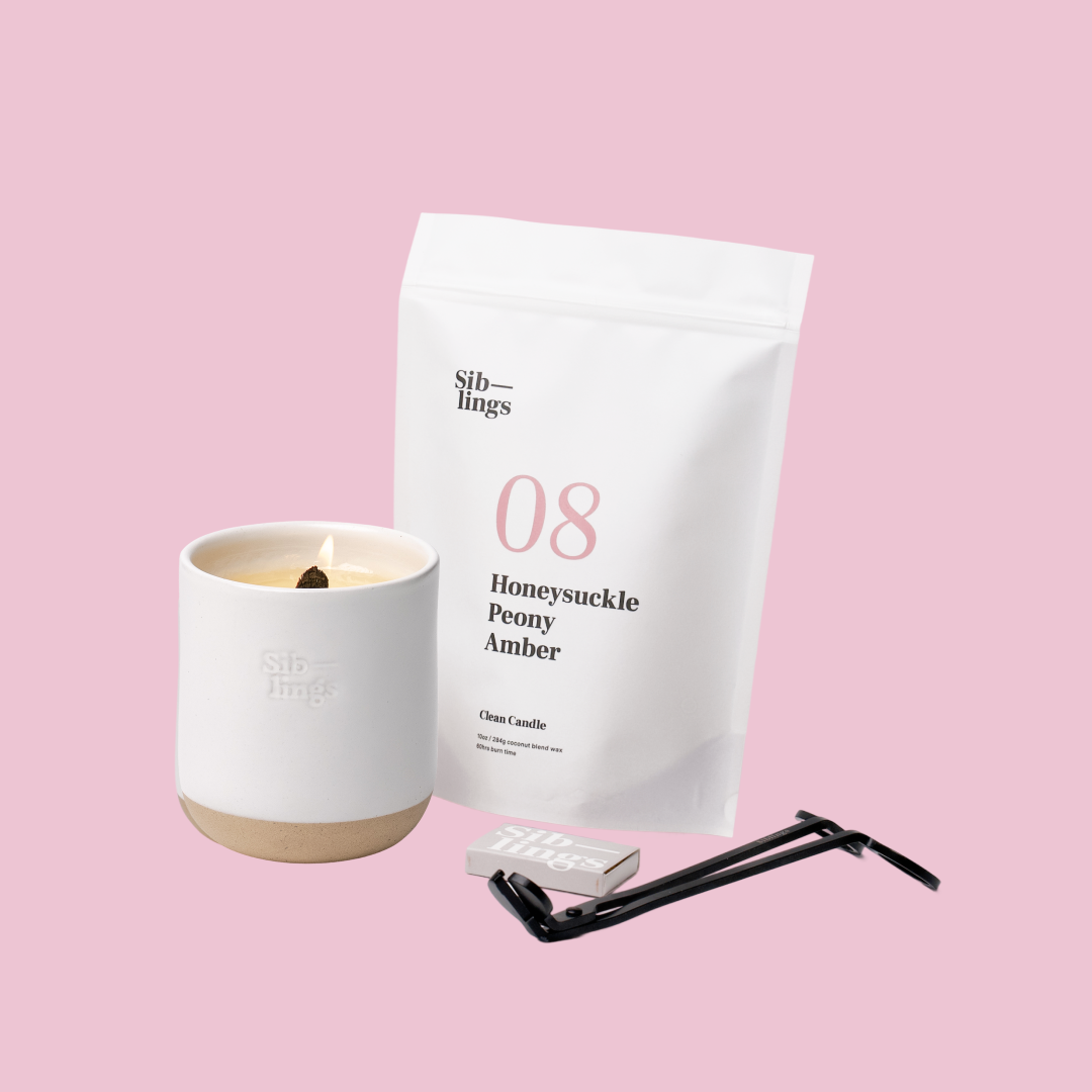 Siblings No. 08 candle starter set with White Cloud vessel, compostable wax refill bag (Peony, Honeysuckle, Amber), and black wick trimmer, showcasing an eco-friendly refill kit.