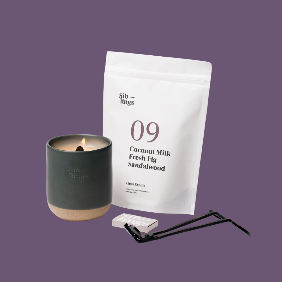 Siblings No. 09 candle starter set with Evergreen vessel, compostable wax refill bag (Coconut Milk, Fig, Sandalwood ), and black wick trimmer, showcasing an eco-friendly refill kit.