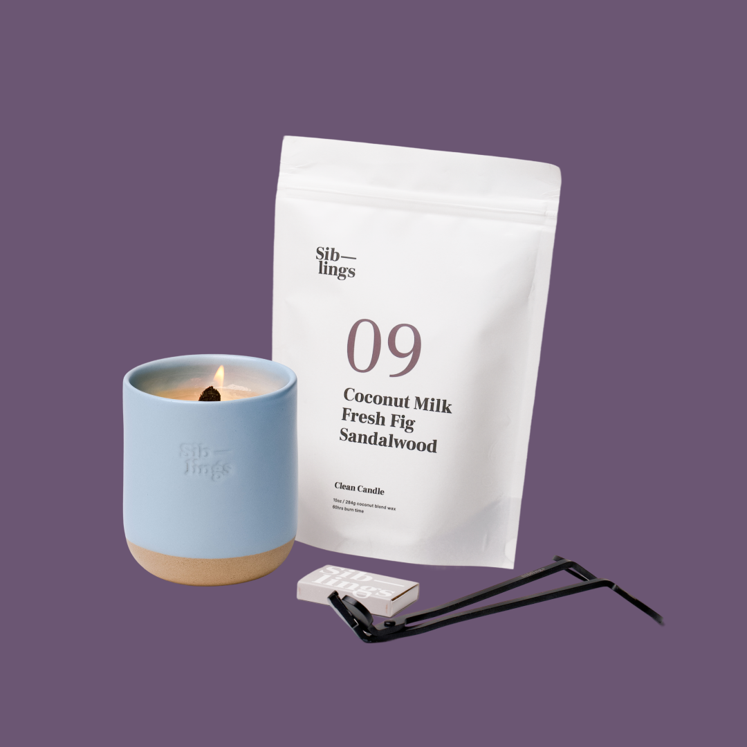 Siblings No. 09 candle starter set with Sky vessel, compostable wax refill bag (Coconut Milk, Fig, Sandalwood), and black wick trimmer, showcasing an eco-friendly refill kit.