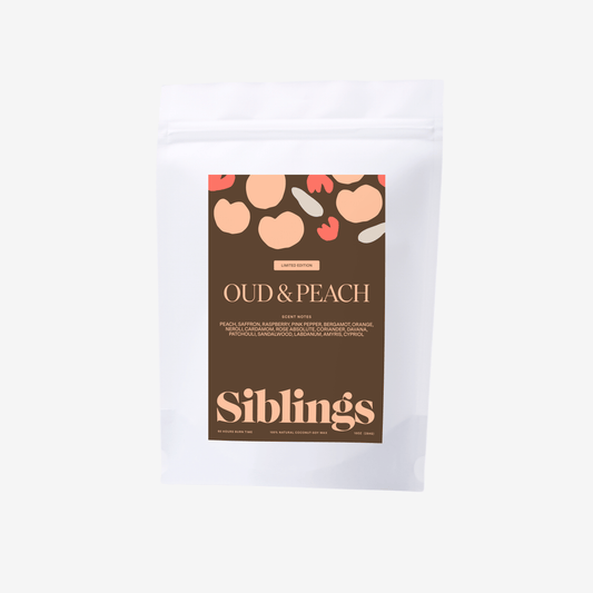 Siblings Oud & Peach candle refill packaging, showcasing luxury fruity-woody scent for home.