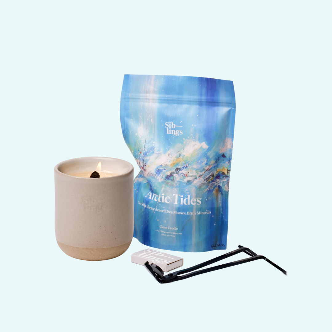 Siblings Arctic Tides candle starter set with Sand vessel, compostable wax refill bag, and black wick trimmer, showcasing an eco-friendly refill kit.